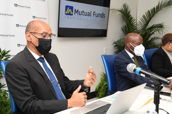 Allan Lewis (left) , managing director, JN Mutual Funds, addressing the JN Mutual Funds Annual General Meeting, recently. At centre is Peter Morris, chairman of JN Mutual Funds and Shakira Pickersgill (partially hidden), company secretary of The Jamaica National Group.